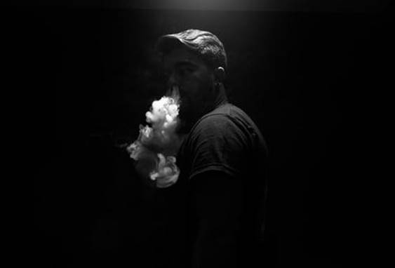 A person vaping CBD oil A person vaping CBD oil